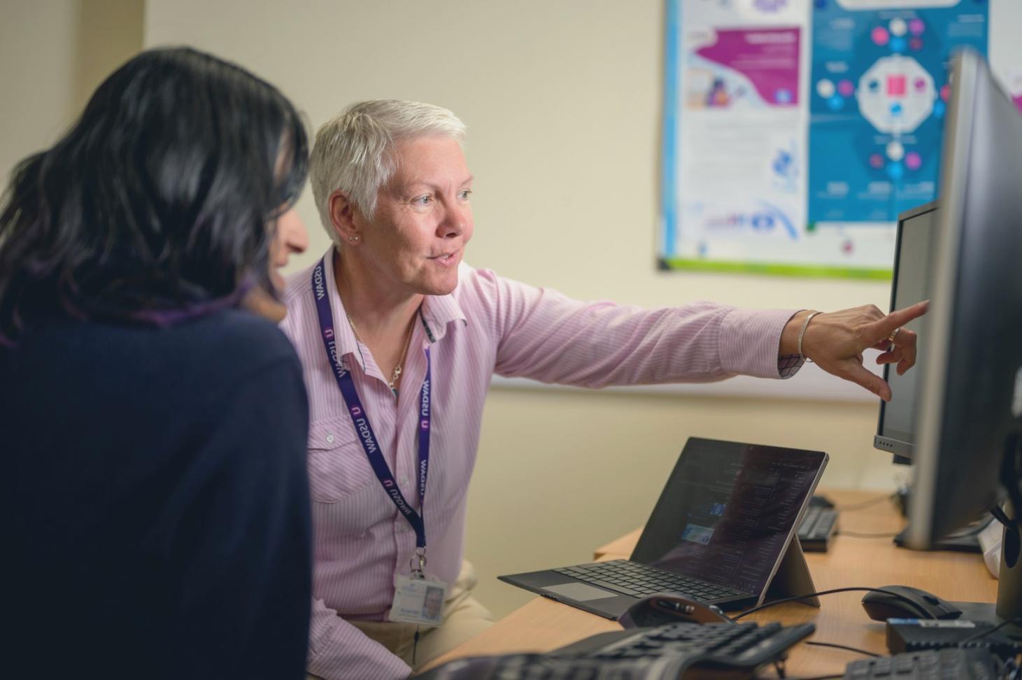 Financial analyst reviewing interpretable ML model output on screen